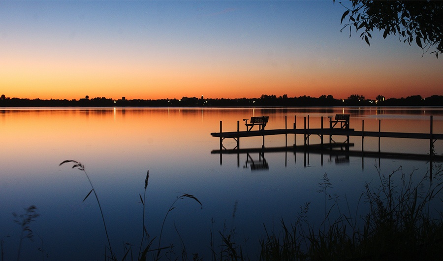 Dock over water at sunset