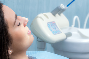 Woman in dental chair with eyes closed