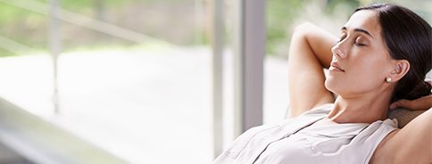 Relaxing woman with hands behind head